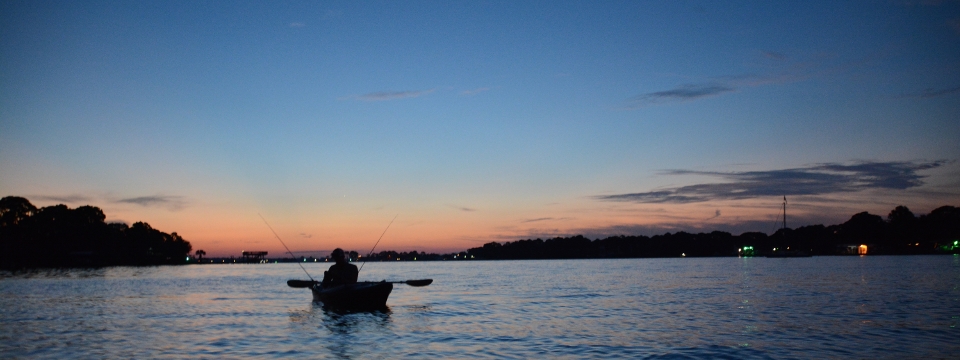 A fisherman at dawn out on Cinco Bayou, Photo by Kate Sievers