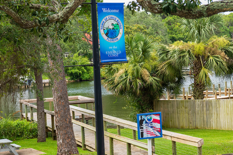 Cinco Bayou flag and dock near the Town Hall, 2021